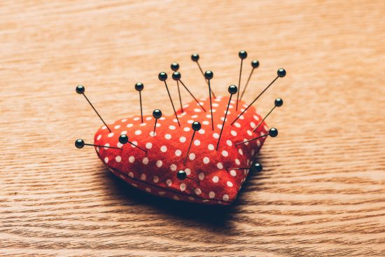 Close-up,Heart,And,Needles,On,Wooden,Background.,Vintage,Style.,Valentines