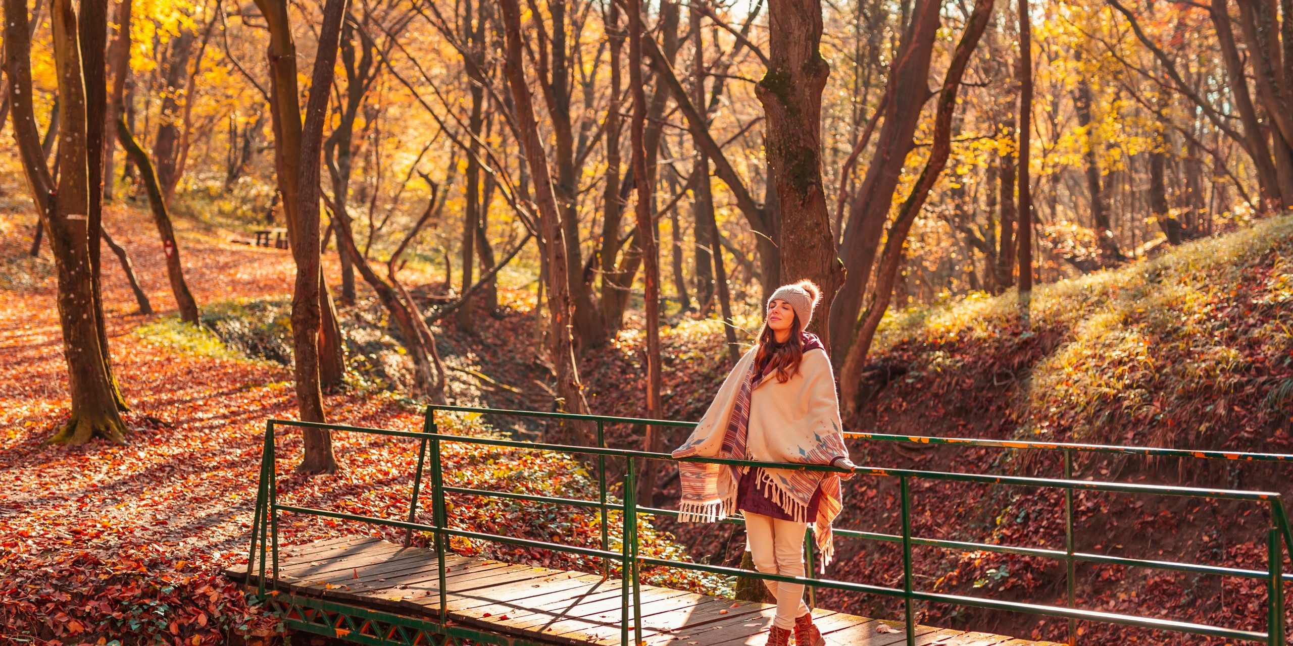 Woman,Walking,Down,The,Bridge,Over,A,Stream,On,The