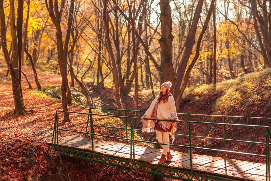 Woman,Walking,Down,The,Bridge,Over,A,Stream,On,The